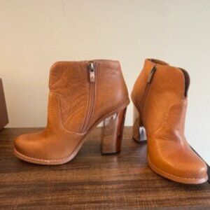 Brown leather zip-up booties with rose gold chrome heel